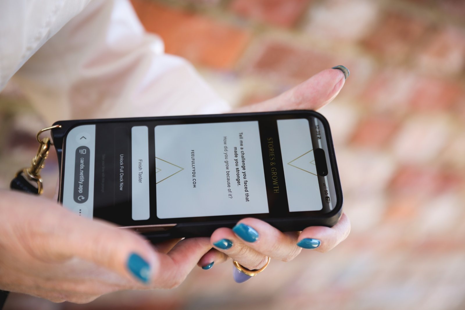 Juliette's hands holding her phone with a card open in the app