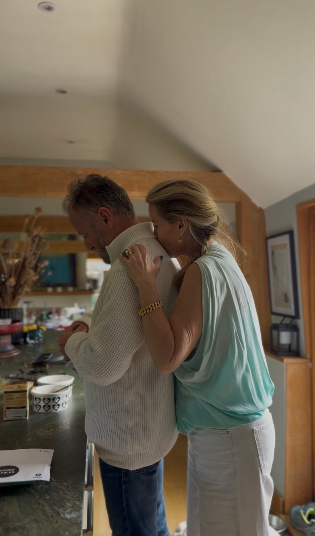 Juliette and Alex hugging in their kitchen