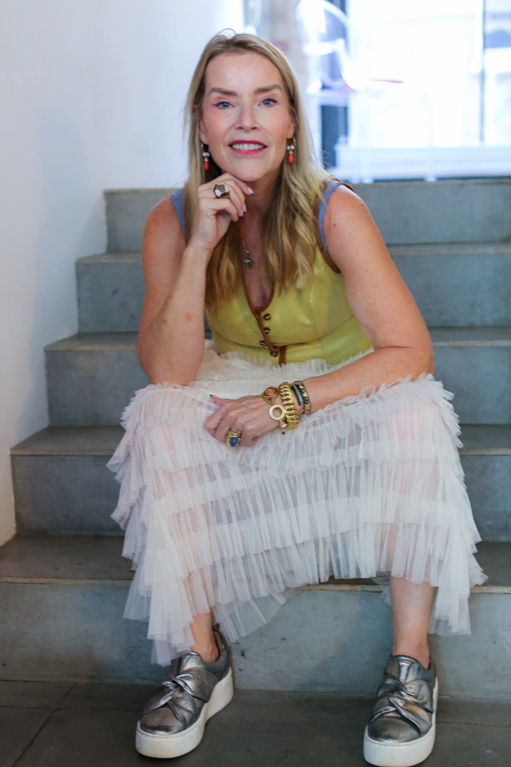 Juliette Karaman sitting on stone steps, smiling