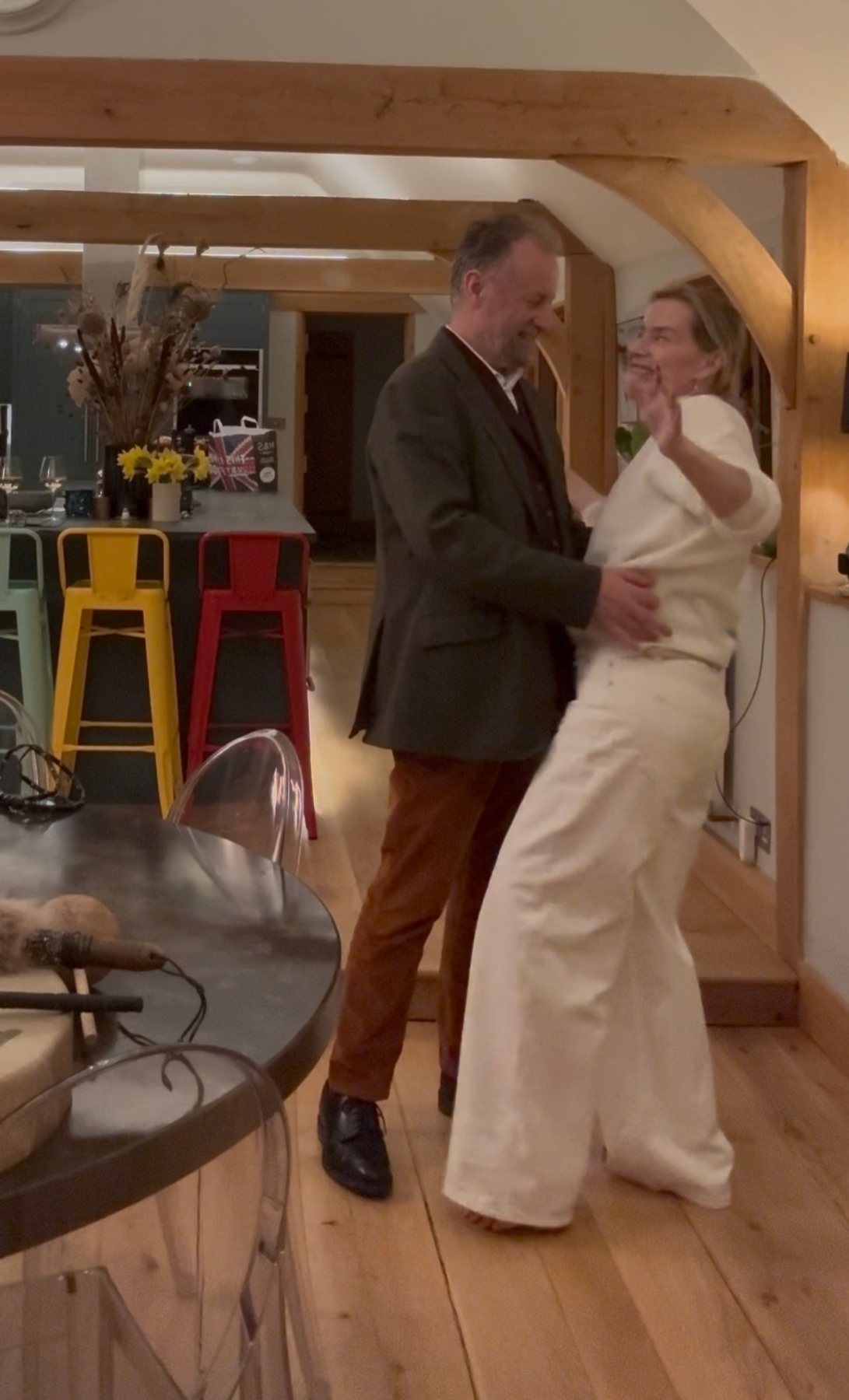 Juliette and Alex dancing and laughing in their kitchen
