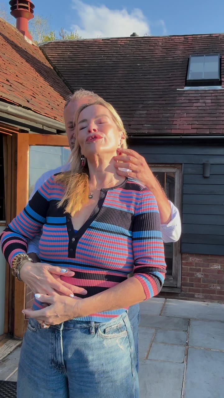 Alex holding Juliette from behind in the sun, her eyes closed, from 31 Touch Points