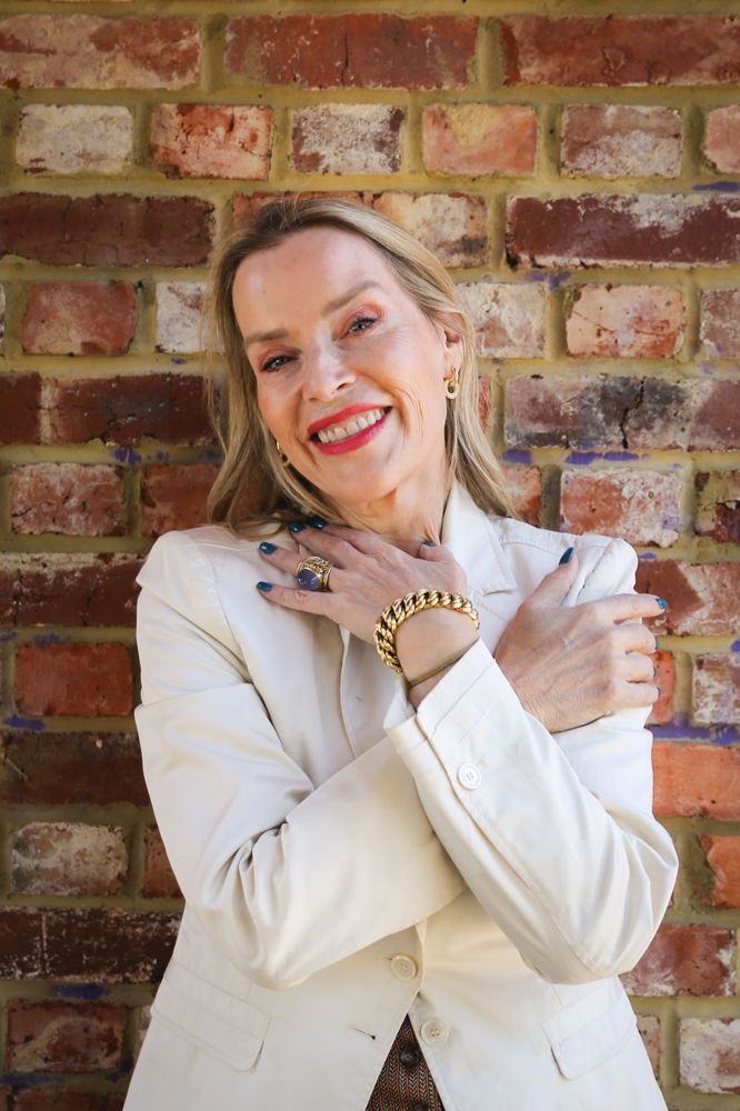 Juliette Karaman, cream jacket brick wall
