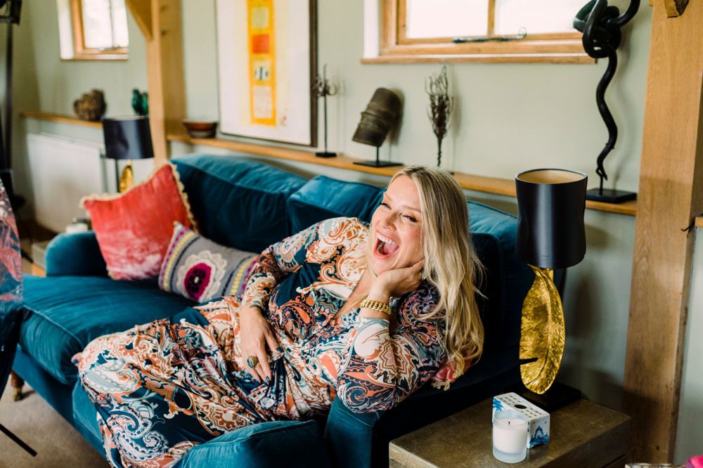 Juliette Karaman, laughing on the sofa