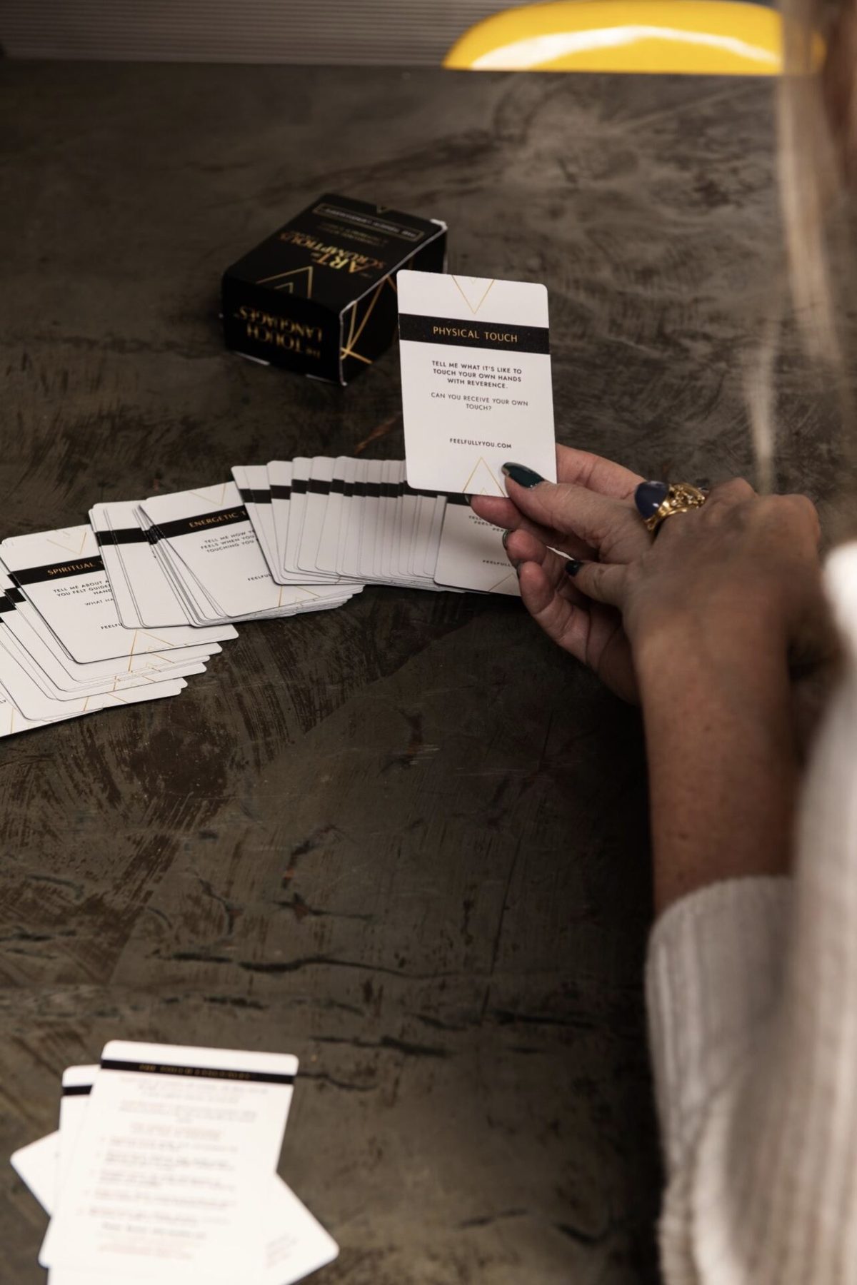 The Touch Languages deck by Juliette Karaman, the Physical Touch card held above the spread